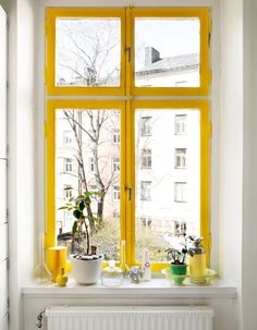 Yellow colored window with sill decor.