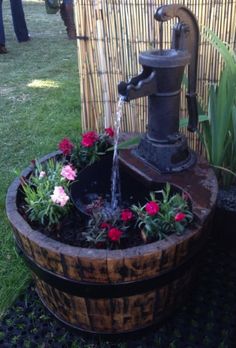 Water flowing from hand pump to wine barrel