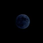 The new moon barely visible in the sky.