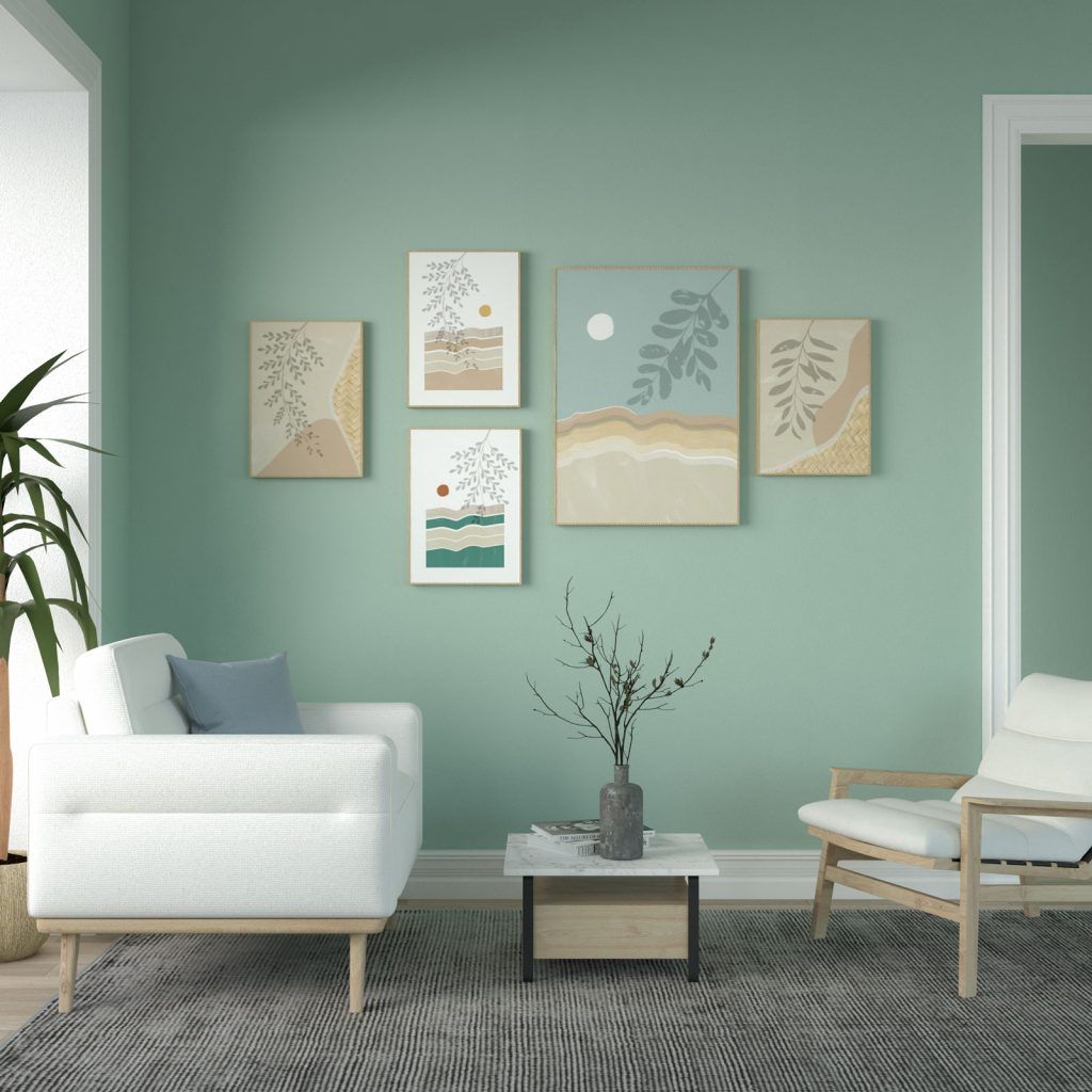 A light-filled living room featuring a prominent, muted sage green accent wall. The room is decorated in a modern, minimalist style with natural and neutral tones.
