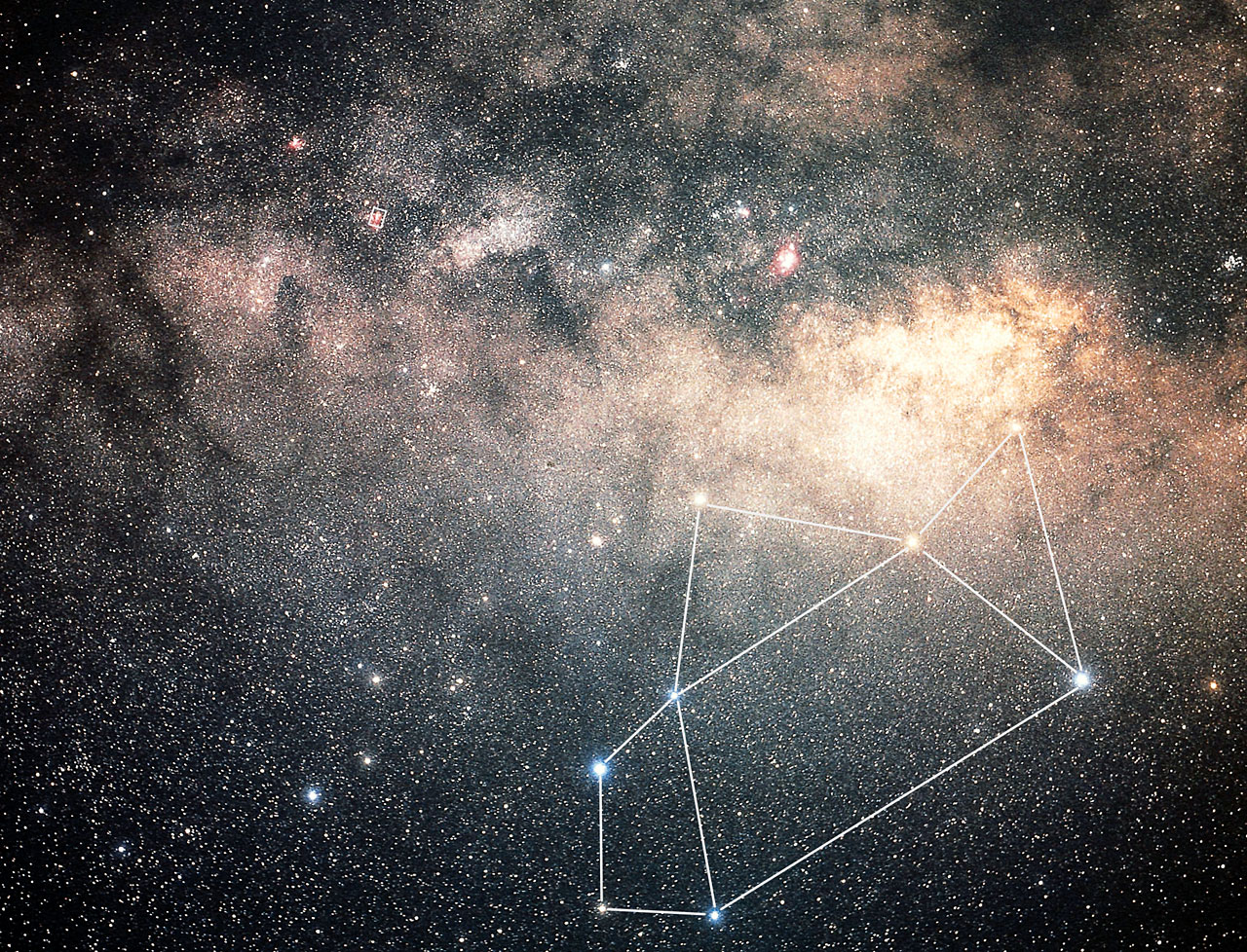 Star-filled Milky Way with a highlighted constellation outlined by white lines against a glowing dusty sky which is Sagittarius.